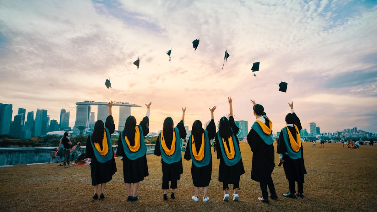 Graduate throwing cap in celebration